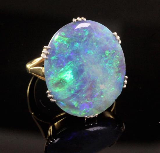 An 18ct gold and platinum set oval black opal dress ring, size L.